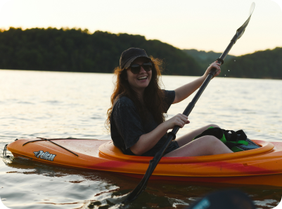 Picture of a one person in an orange kayak on a lake